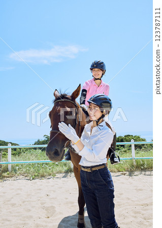 A woman practicing horse riding A woman practicing horse riding 123787111