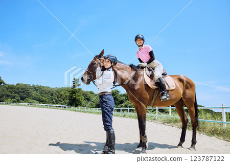 A woman practicing horse riding 123787122