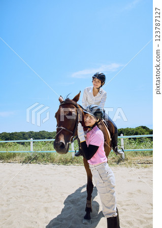 A woman practicing horse riding 123787127