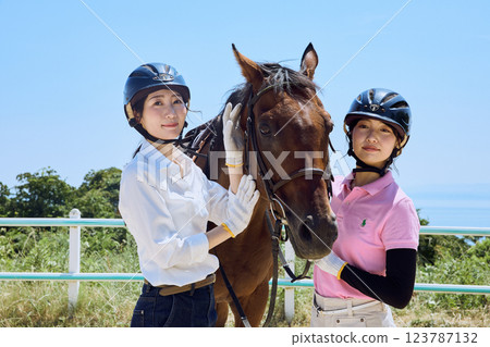 A woman practicing horse riding A woman practicing horse riding 123787132
