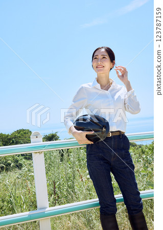 一名女子在騎馬俱樂部戴著頭盔，抬頭望向天空 123787159