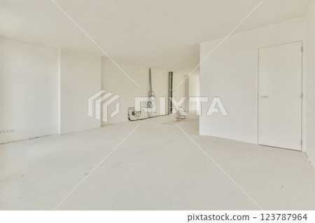 An empty minimalist interior space featuring white walls and a simple design, creating a calm and serene atmosphere ready for decoration. 123787964