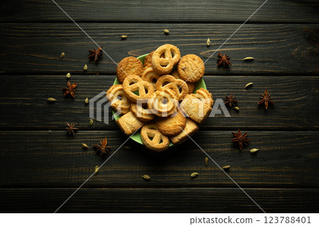 A vibrant collection of assorted cookies is beautifully displayed on a green plate. Rich textures and intricate shapes showcase the artisan quality, inviting sweet indulgence and shared moments A vibrant collection of assorted cookies is beautifully displayed on a green plate. Rich textures and intricate shapes showcase the artisan quality, inviting sweet indulgence and shared moments 123788401