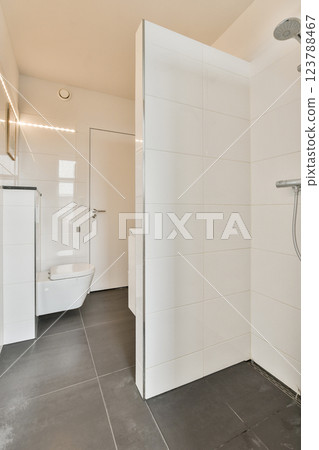 A sleek and contemporary bathroom featuring clean lines, white tiles, and spacious layouts that embody modern aesthetics and functionality. A sleek and contemporary bathroom featuring clean lines, white tiles, and spacious layouts that embody modern aesthetics and functionality. 123788467