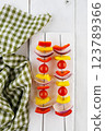 Vegetable kebab on skewers on a light wooden background 123789366