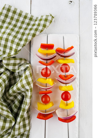 Vegetable kebab on skewers on a light wooden background Vegetable kebab on skewers on a light wooden background 123789366