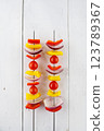 Vegetable kebab on skewers on a light wooden background 123789367