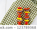 Vegetable kebab on skewers on a light wooden background 123789368