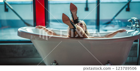 Woman feet high heels shoes in bathrobe at home, closeup 123789506