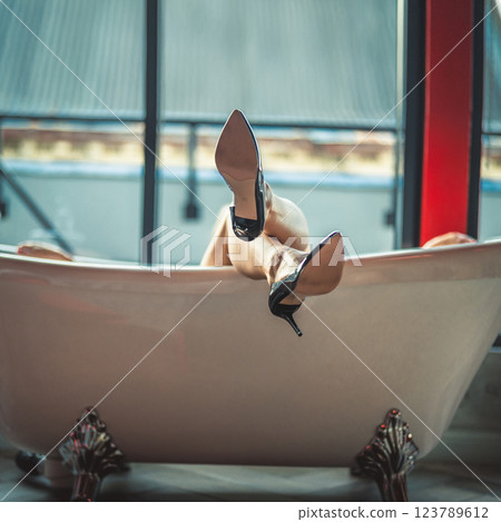 Woman feet high heels shoes in bathrobe at home, closeup 123789612