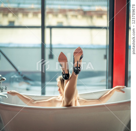 Woman feet high heels shoes in bathrobe at home, closeup Woman feet high heels shoes in bathrobe at home, closeup 123789678