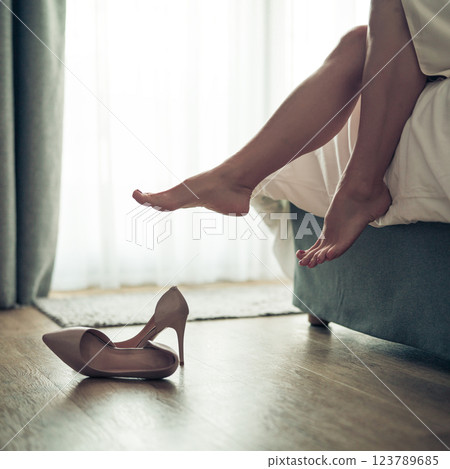 Womans feet in white bathrobe lying on sofa and relaxing at the room 123789685