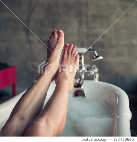 Woman feet in bathrobe at home, closeup 123789690