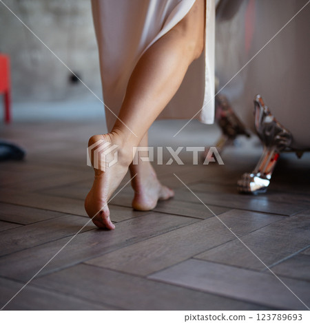 Woman feet in bathrobe at home, closeup Woman feet in bathrobe at home, closeup 123789693