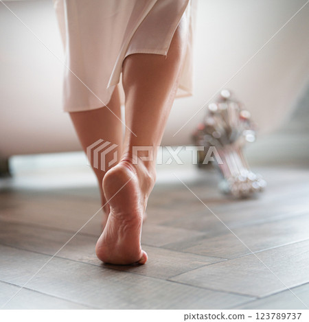 Woman feet in bathrobe at home, closeup 123789737