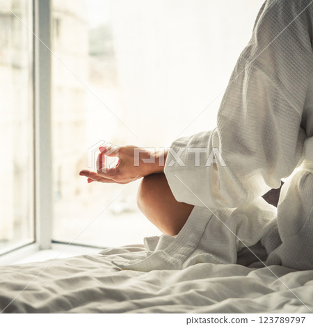 Woman in white bathrobe lying on sofa and relaxing at hotel room. 123789797