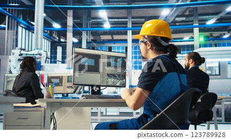 Photovoltaics factory specialist building models of renewable energy generators. Solar panels manufacturing plant technician building environmentally safe solar cells, camera A 123789928