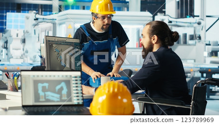 Photovoltaics factory engineer with paraplegia in wheelchair improving solar panels efficiency. Solar panels manufacturing plant worker with disability researching cheaper solar solutions, camera B 123789969
