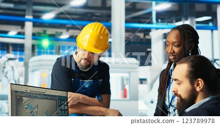 Photovoltaics factory manager gives task to worker after monitoring system performance. Solar panels manufacturing plant supervisor sends engineer to improve energy production and efficiency, camera B Photovoltaics factory manager gives task to worker after monitoring system performance. Solar panels manufacturing plant supervisor sends engineer to improve energy production and efficiency, camera B 123789978