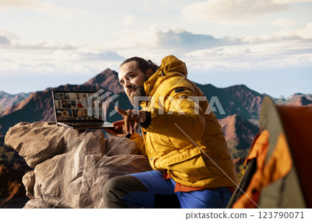 Adventure seeker having internet everywhere and using video call discussion, chatting with colleagues on the top of the mountain. Hiker with a technology obsession and dependency. Adventure seeker having internet everywhere and using video call discussion, chatting with colleagues on the top of the mountain. Hiker with a technology obsession and dependency. 123790071