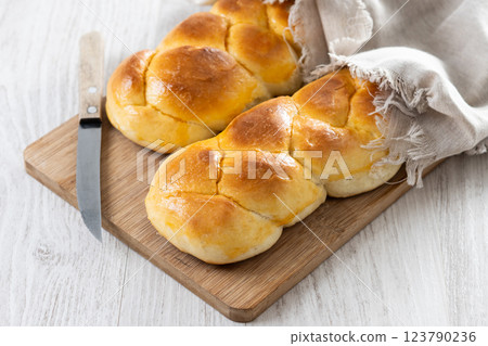 Traditional Easter braided bread. Tsoureki braid on wooden table Traditional Easter braided bread. Tsoureki braid on wooden table 123790236