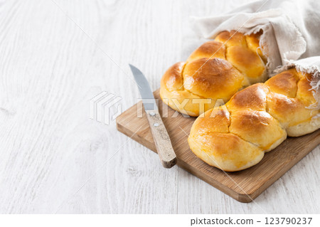 Traditional Easter braided bread. Tsoureki braid on wooden table Traditional Easter braided bread. Tsoureki braid on wooden table 123790237
