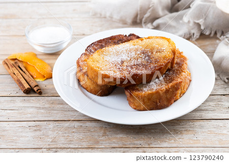Traditional Spanish torrijas for Holy Week on wooden table. French Toast. Traditional Spanish torrijas for Holy Week on wooden table. French Toast. 123790240