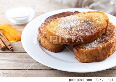Traditional Spanish torrijas for Holy Week on wooden table. French Toast. Traditional Spanish torrijas for Holy Week on wooden table. French Toast. 123790241