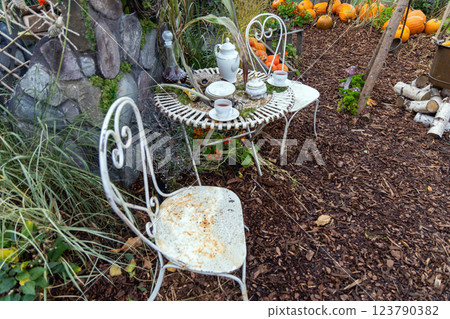 Empty table in autumn garden decorated for Halloween 123790382