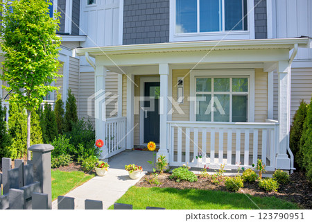 Residential house with open patio under the porch on sunny spring day 123790951