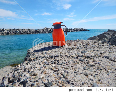 Orange thermos jug. 123791461