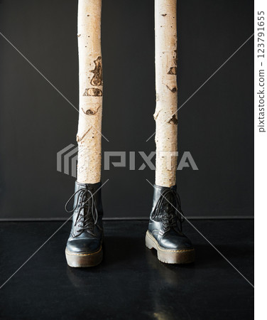 Surreal birch tree legs wearing black boots Surreal birch tree legs wearing black boots 123791655