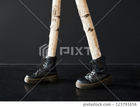 Surreal birch tree legs wearing black boots Surreal birch tree legs wearing black boots 123791656