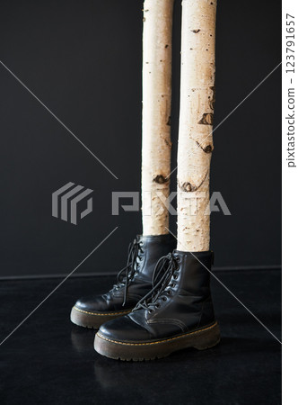 Surreal birch tree legs wearing black boots Surreal birch tree legs wearing black boots 123791657