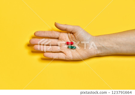 Various pills of different colors and shapes at hand 123791664