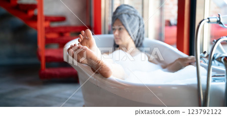 Woman feet in bathrobe at home, closeup 123792122