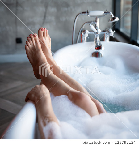 Woman feet in bathrobe at home, closeup 123792124