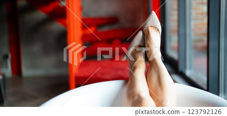 Woman feet high heels shoes in bathrobe at home, closeup Woman feet high heels shoes in bathrobe at home, closeup 123792126