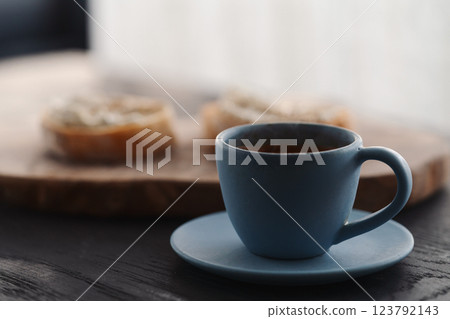 Espresso in blue cup with sandwiches with cream cheese on background 123792143