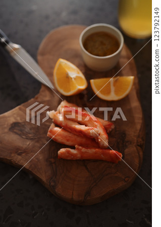 Crab legs with lemon and dressing on olive woob board 123792149