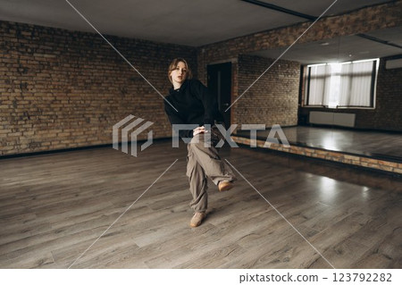 Dance practice in a spacious studio with brick walls and mirrors Dance practice in a spacious studio with brick walls and mirrors 123792282