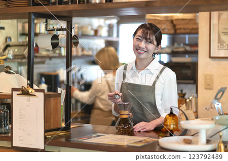 A cafe attendant preparing to make coffee A cafe attendant preparing to make coffee 123792489