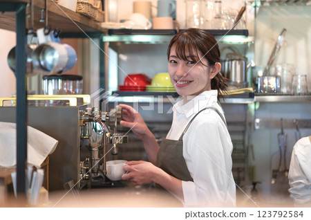 A cafe attendant preparing to make coffee A cafe attendant preparing to make coffee 123792584