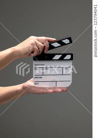 A hand with clapperboard A hand with clapperboard 123794041
