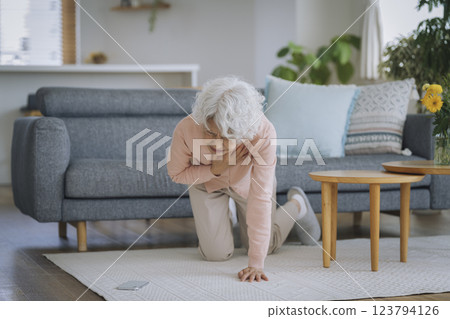 Senior woman collapses while holding her chest 123794126
