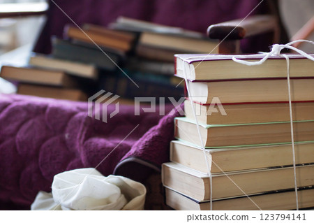 A neat stack of books that are tied together securely with a string A neat stack of books that are tied together securely with a string 123794141