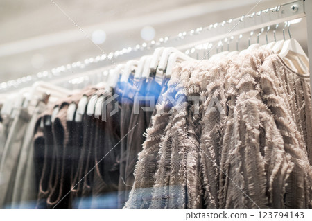 A vibrant row of clothing beautifully displayed on a rack in a store A vibrant row of clothing beautifully displayed on a rack in a store 123794143