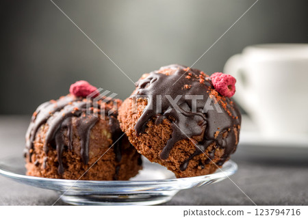 Round chocolate cakes. Decorated with candied raspberries. Dark background Round chocolate cakes. Decorated with candied raspberries. Dark background 123794716