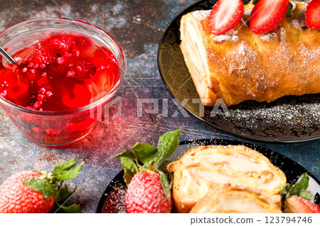 Sliced rolls with custard. The dessert is decorated with fresh strawberries Sliced rolls with custard. The dessert is decorated with fresh strawberries 123794746