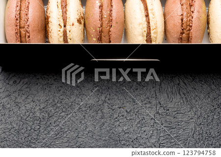 Macaroons in a black cardboard box on a dark background Macaroons in a black cardboard box on a dark background 123794758